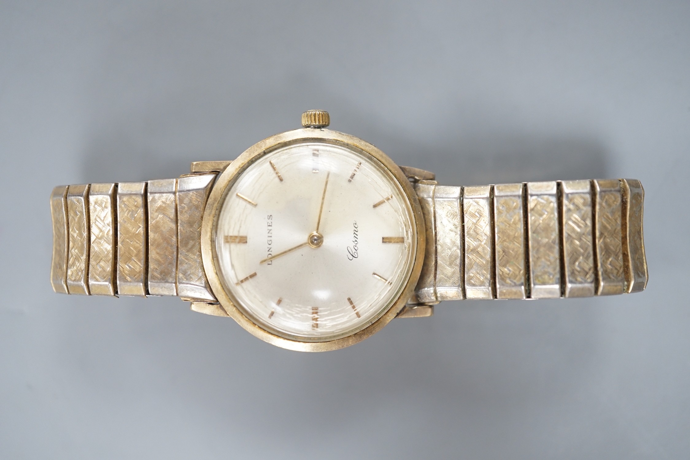 A gentleman's 9ct gold Longines Cosmic manual wind wrist watch, on associated flexible bracelet.